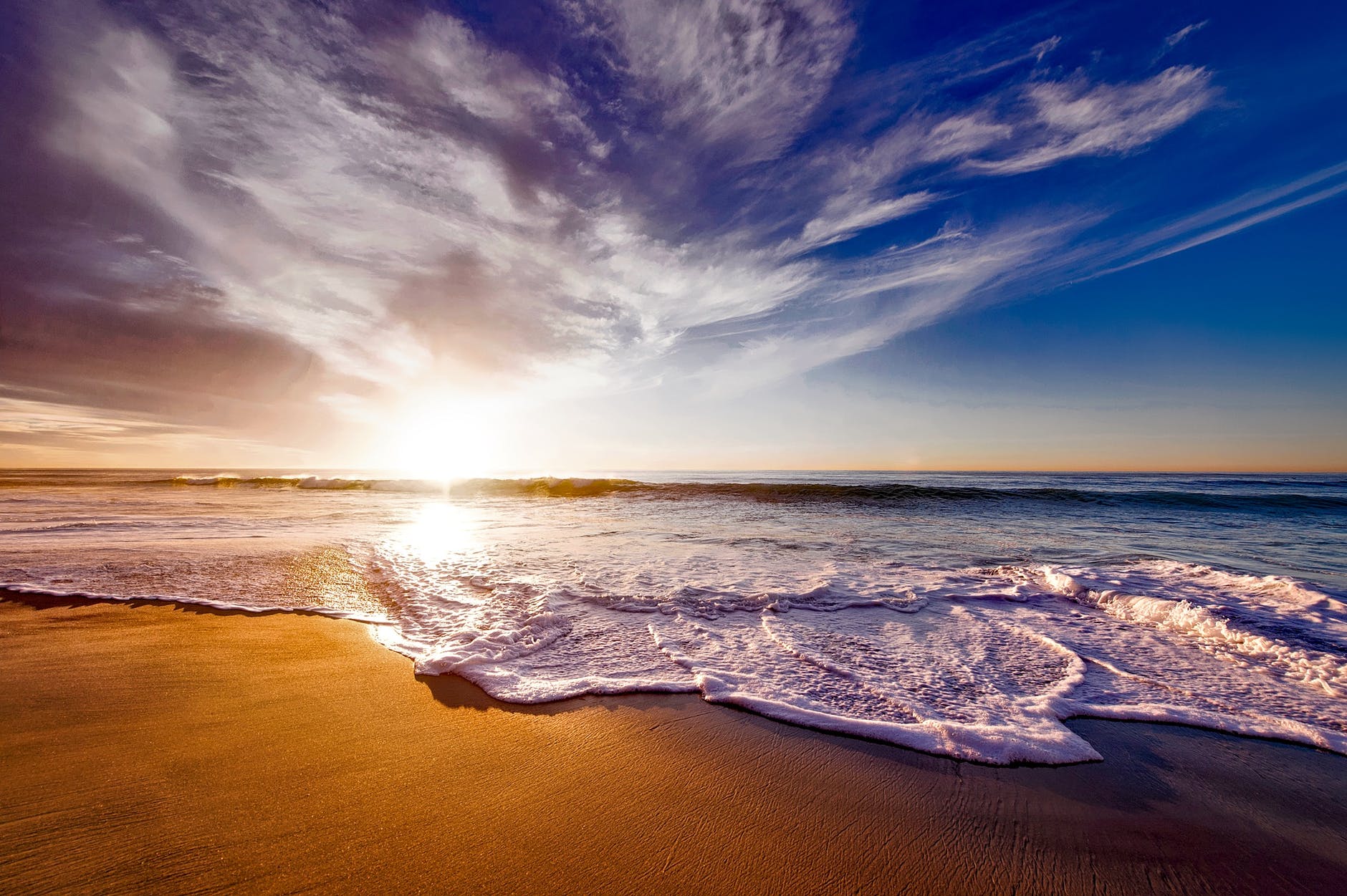 seashore under white and blue sky during sunset